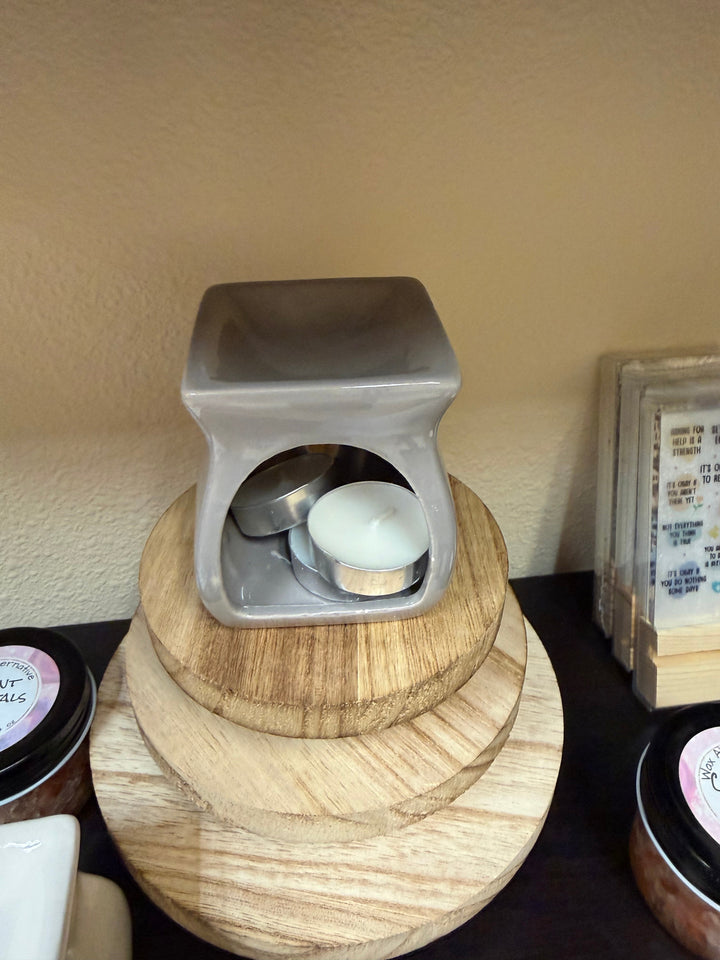 Salt and wax warmer in glossy gray ceramic with tealights in the base