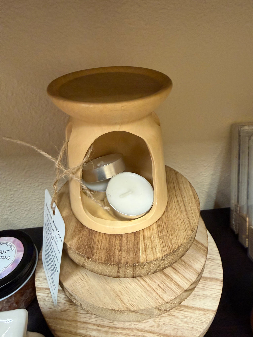 Salt and wax warmer in glossy black ceramic with tealights in the base
