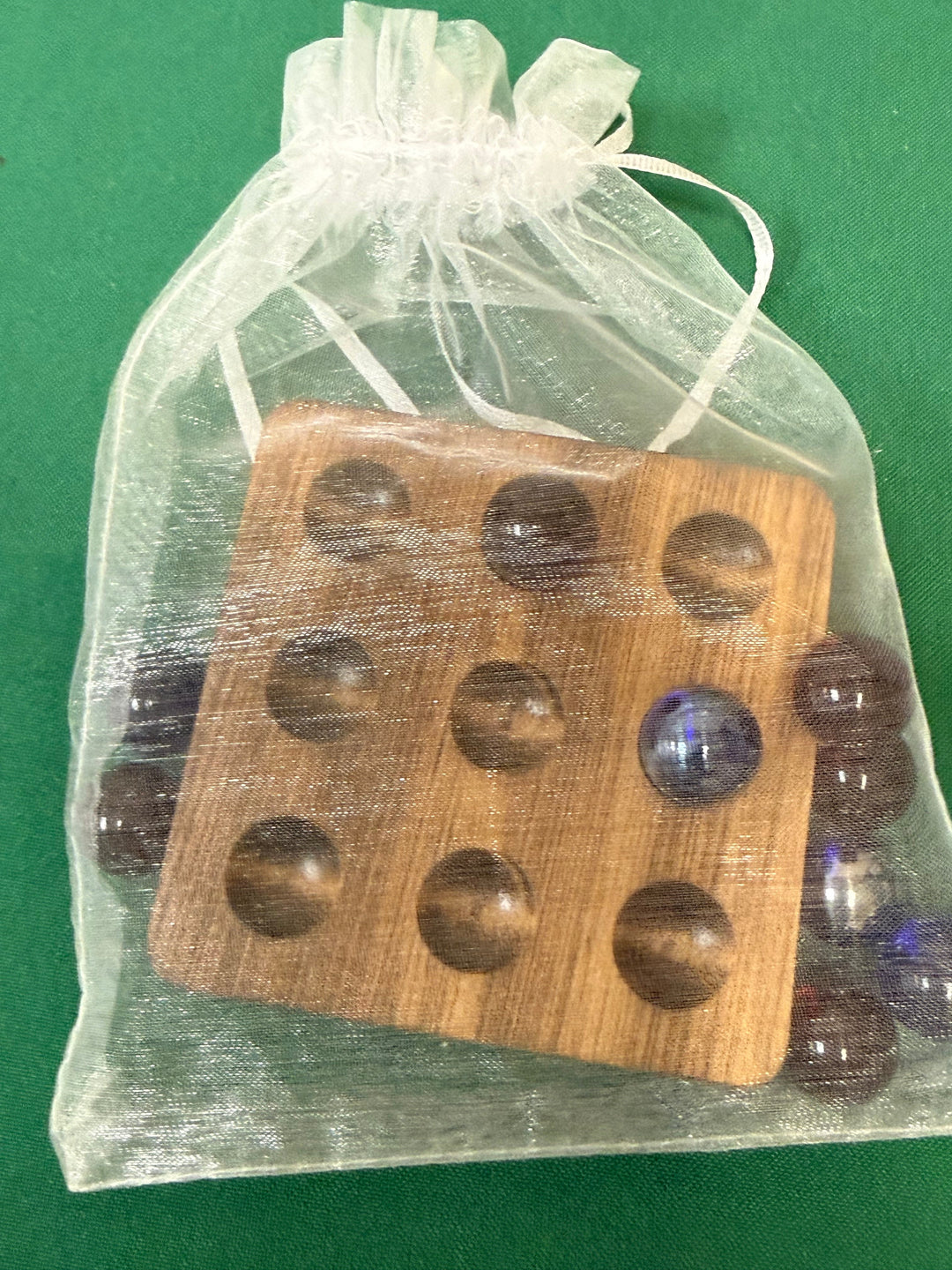 Handmade wooden tic tac toe board with glass marbles, packed in a sheer organza gift bag
