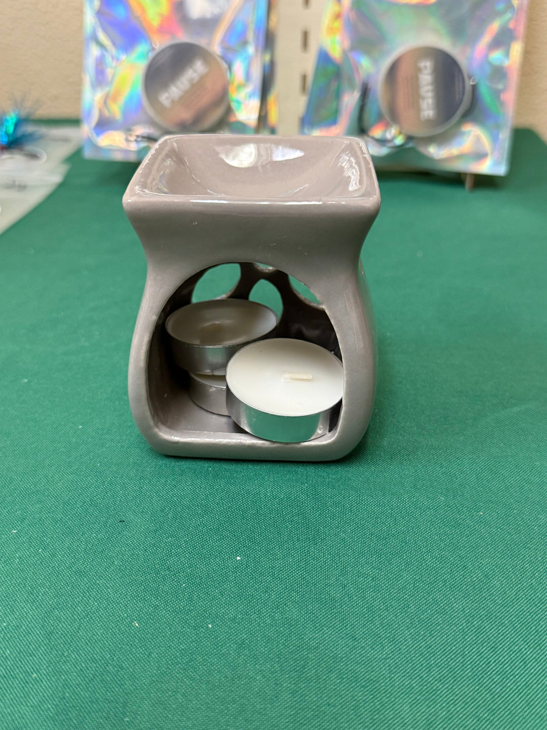 Gray ceramic salt and wax warmer with tealights, shown on a plain backdrop