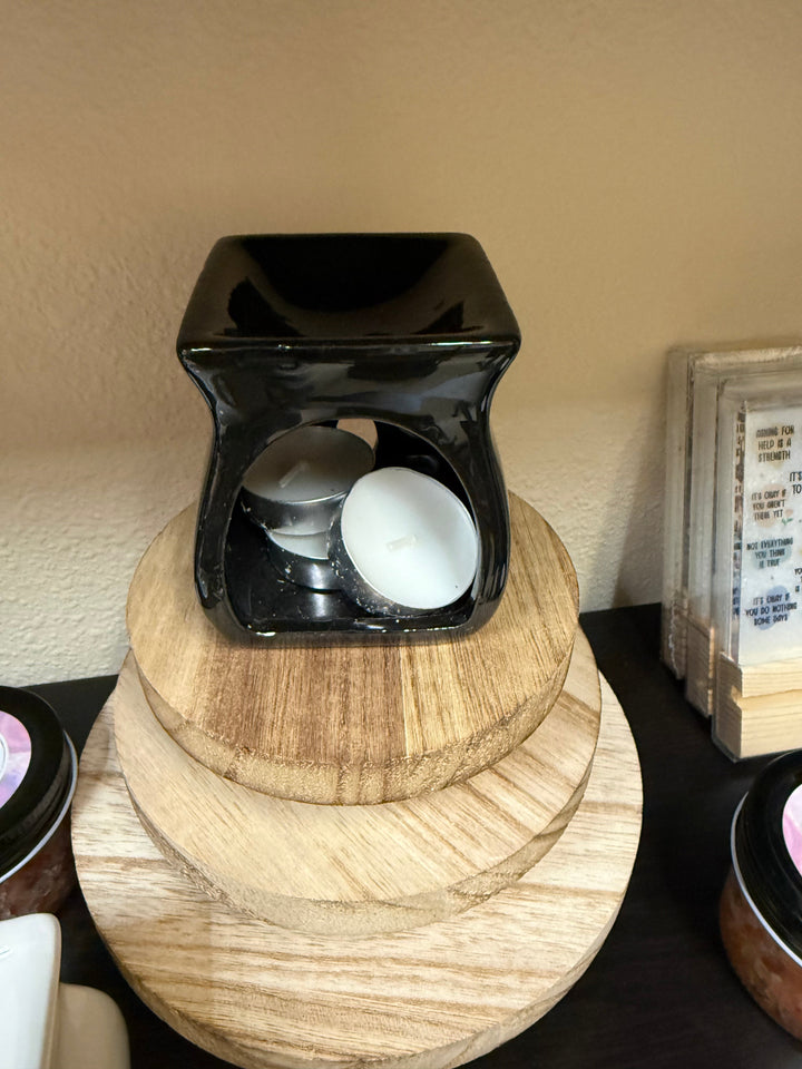 Salt and wax warmer in natural wood tone with tealights in the base
