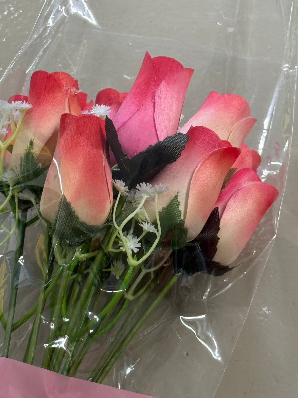 Coral ombré wooden rose bouquet wrapped with baby’s breath